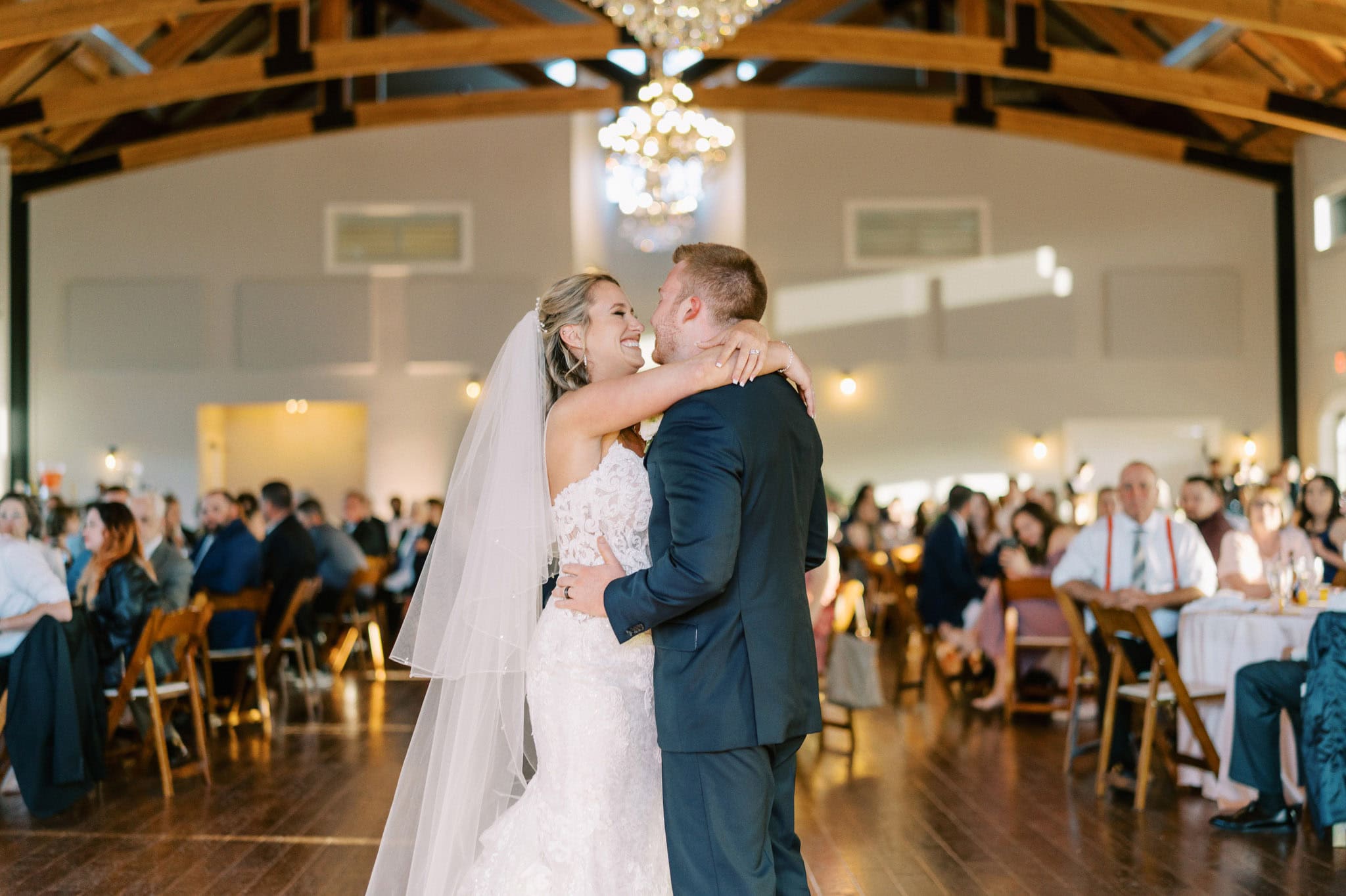 Wedding couple sharing a dance at their reception in a beautifully decorated venue.